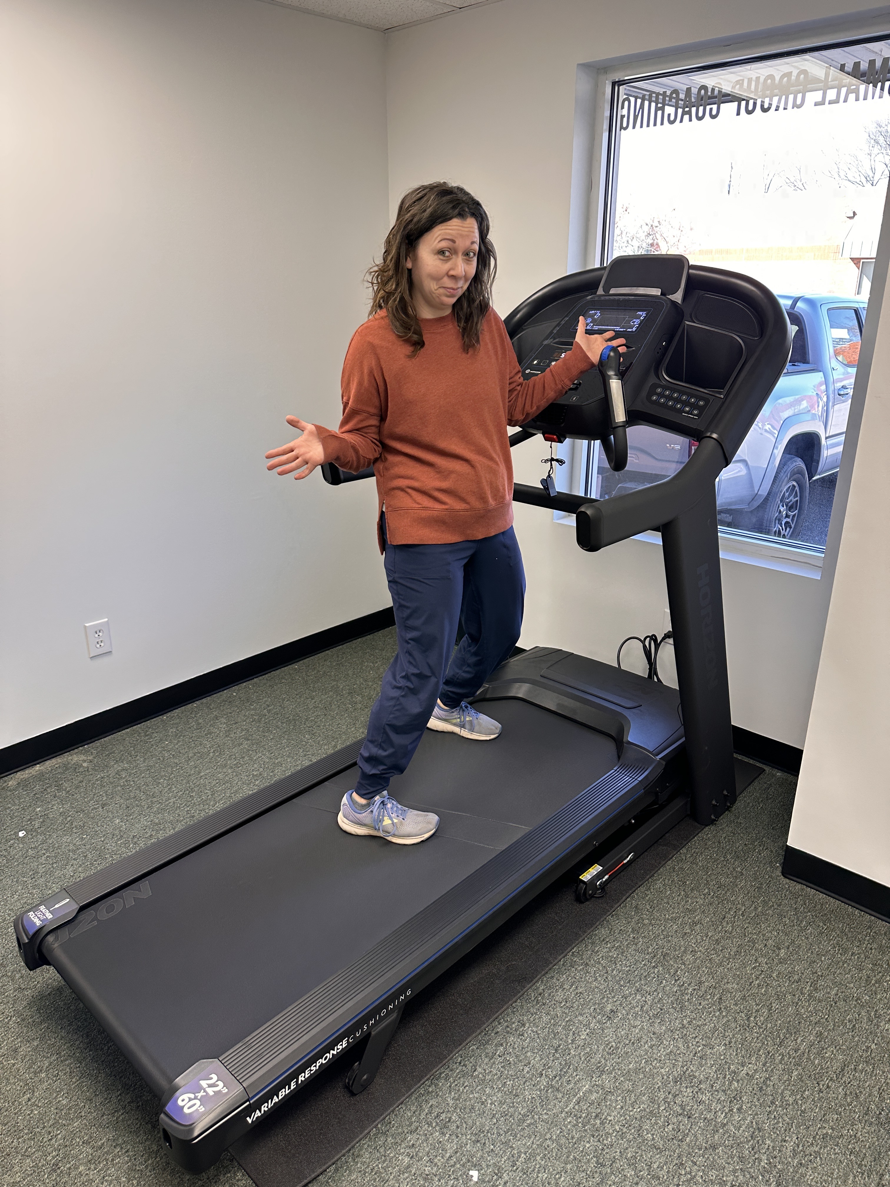 Dr. Sam stands on treadmill in her running lab